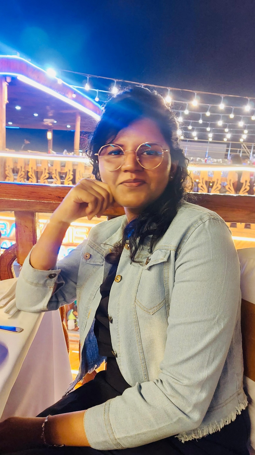 32°N designer at an evening dinner outing with string lights